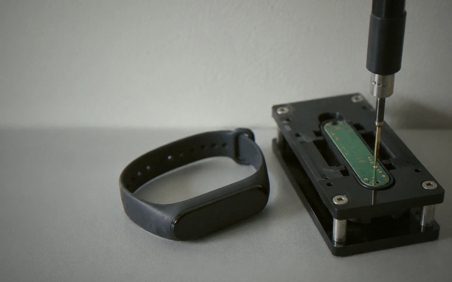 Wearable prototype clamped in a test fixture on an engineering bench