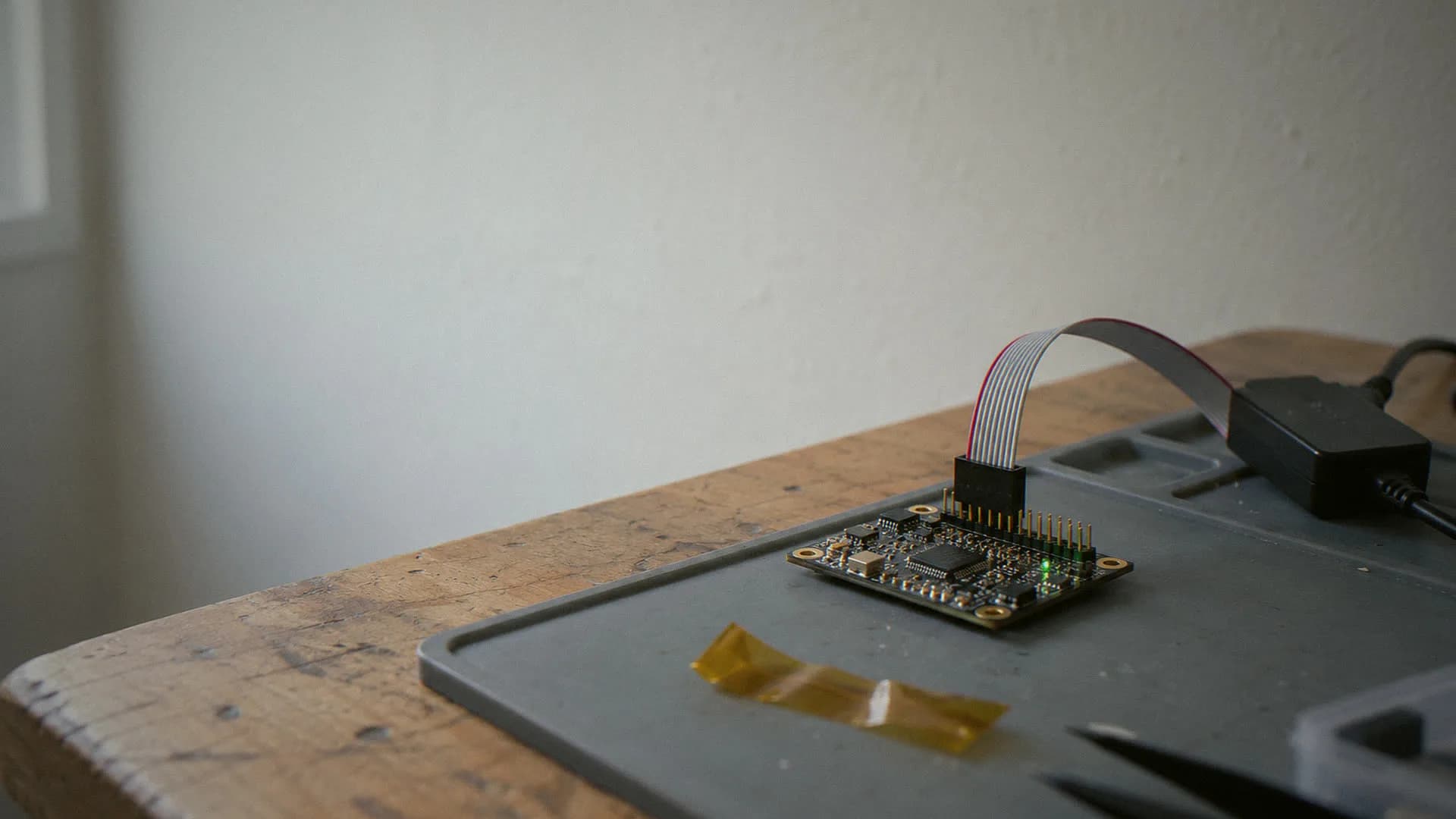 Dev board with a ribbon cable to a debug probe